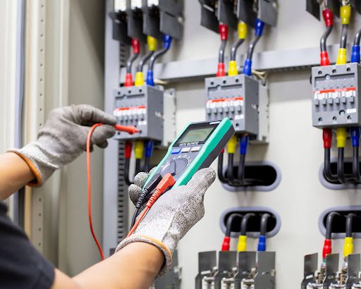 Someone performing tests on electrical infrastructure